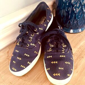 Keds navy lace up sneakers with gold print.